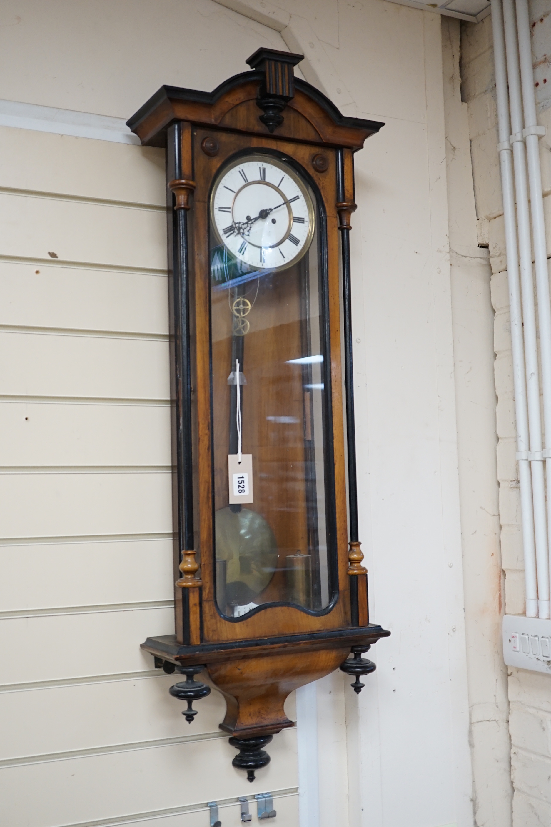 A 19th century Viennese regulator with key and weights, striking on a coiled gong, 107cm high